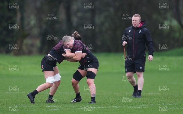 190324 - Wales Women Rugby Training - Alex Callender and Alisha Butchers are watched by Jamie Cox during training session ahead of the start of the Women’s 6 Nations