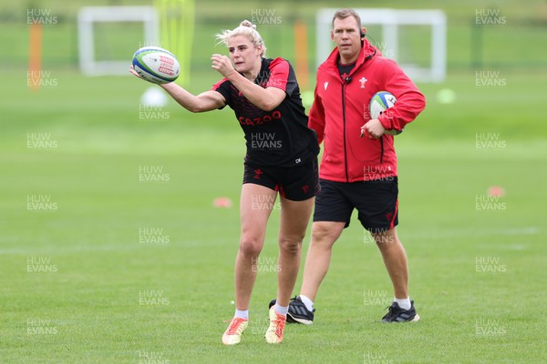 190922 - Wales Women World Cup Squad Training session - Carys Williams-Morris feeds the ball out as Ioan Cunningham looks on during a training session ahead of Wales’ departure for the Women’s Rugby World Cup