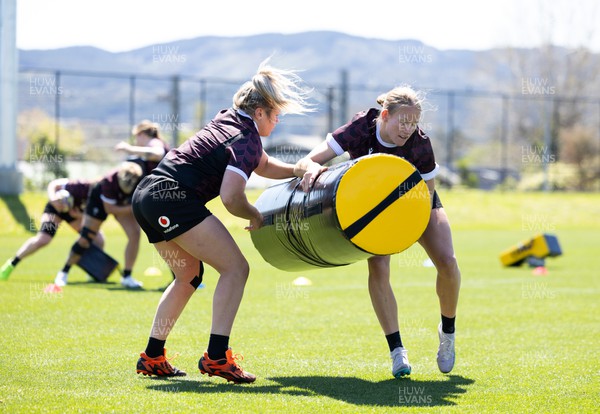 191023 - Wales Women Rugby Training Session - Carys Cox and Hannah Bluck work on the tackle bags during a training session ahead of Wales’ opening match of WXV1 against Canada