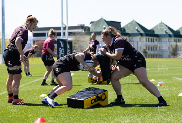 191023 - Wales Women Rugby Training Session - Kate Williams, Kat Evans and Gwenllian Pyrs work on the tackle shields during a training session ahead of Wales’ opening match of WXV1 against Canada