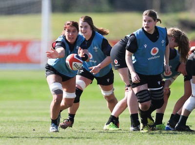 200325  Wales Women Rugby Training Session - Georgia Evans watched by Bethan Lewis and Kate Williams during training session ahead of the opening match of the Women’s 6 Nations against Scotland