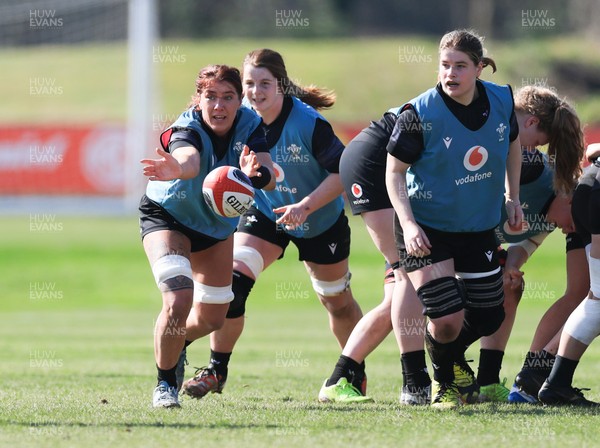 200325  Wales Women Rugby Training Session - Georgia Evans watched by Bethan Lewis and Kate Williams during training session ahead of the opening match of the Women’s 6 Nations against Scotland