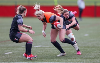 210323 - Wales Women Rugby Training Session - Carys Williams-Morris gets away from Amelia Tutt during a training session ahead of Wales’ opening Women’s 6 Nations match against Ireland