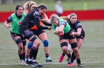 210323 - Wales Women Rugby Training Session - Alex Callender takes on Charlie Munday and Amelia Tutt during a training session ahead of Wales’ opening Women’s 6 Nations match against Ireland