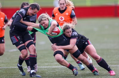 210323 - Wales Women Rugby Training Session - Alex Callender takes on Charlie Munday and Amelia Tutt during a training session ahead of Wales’ opening Women’s 6 Nations match against Ireland