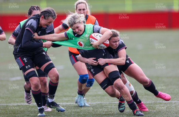 210323 - Wales Women Rugby Training Session - Alex Callender takes on Charlie Munday and Amelia Tutt during a training session ahead of Wales’ opening Women’s 6 Nations match against Ireland