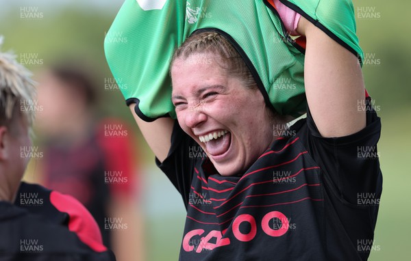 220822 - Wales Women Rugby in Canada - Georgia Evans shares a joke during the first training session at their training base just outside Halifax