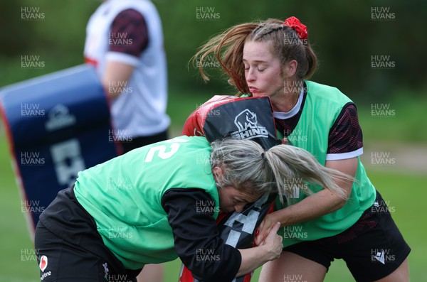 230424 - Wales Women Rugby Training -  Hannah Bluck takes on Lisa Neumann during training ahead of Wales’ Guinness Women’s 6 Nations match against Italy