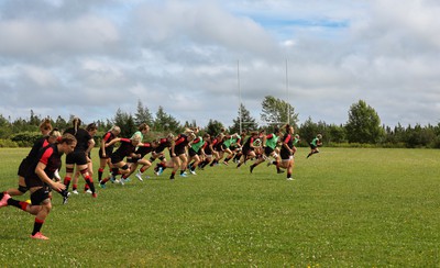 230822 - Wales Women rugby squad players warm up during a training session against the Canadian Women’s rugby squad near Halifax