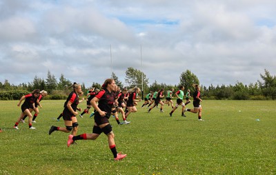 230822 - Wales Women rugby squad players warm up during a training session against the Canadian Women’s rugby squad near Halifax