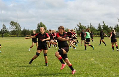 230822 - Wales Women rugby squad players warm up during a training session against the Canadian Women’s rugby squad near Halifax