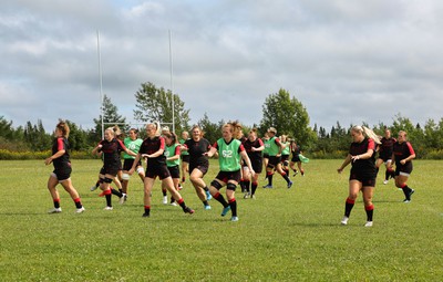 230822 - Wales Women rugby squad players warm up during a training session against the Canadian Women’s rugby squad near Halifax