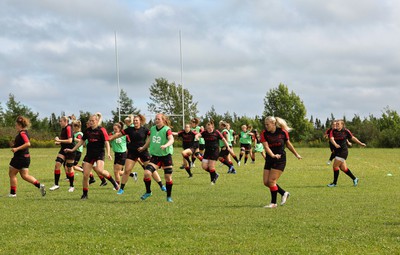 230822 - Wales Women rugby squad players warm up during a training session against the Canadian Women’s rugby squad near Halifax