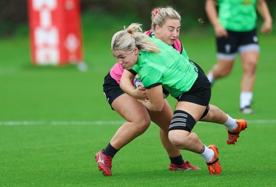 230926 Wales Women Rugby Training Session - Alex Callender is tackled by Molly Reardon during a training session ahead of the WXV match against the USA