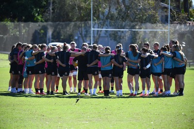 240725 - Wales Women Rugby Training at The Southport School, Southport - The Wales squad huddle up during a Wales Womens Rugby training session ahead of their first tour match against Australia
