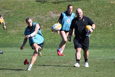 240725 - Wales Women Rugby Training at The Southport School, Southport - Keira Bevan is watched by Sean Lynn, Wales Women head coach during a Wales Womens Rugby training session ahead of their first tour match against Australia
