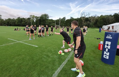 240823 - Wales Women Training session - Jamie Cox feeds the ball to the players during training session