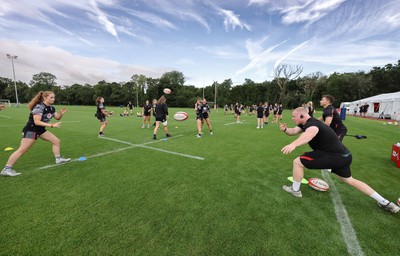 240823 - Wales Women Training session - Jamie Cox feeds the ball to the players during training session