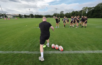 240823 - Wales Women Training session - Jamie Cox feeds the ball to the players during training session