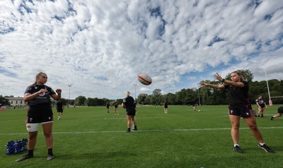 240823 - Wales Women Training session - Bryonie King, left and Amelia Tutt work together at the end of the session