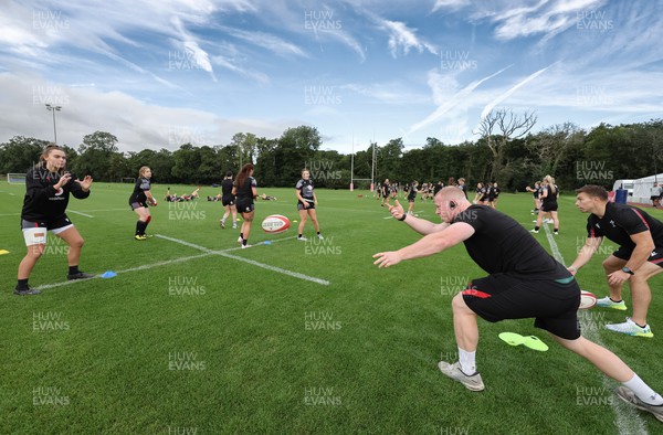 240823 - Wales Women Training session - Jamie Cox feeds the ball to the players during training session