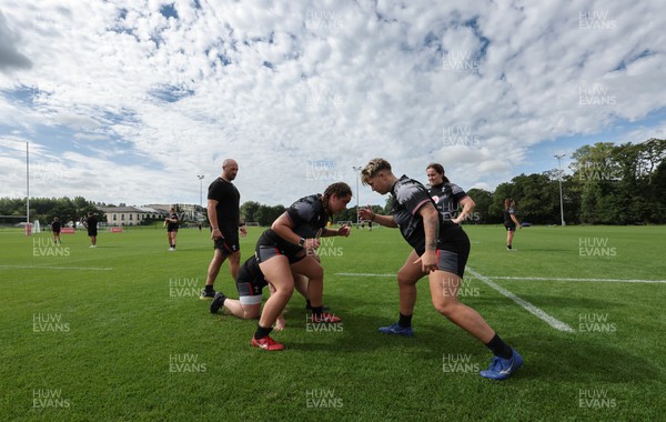 240823 - Wales Women Training session - Cana Williams and Donna Rose go through a session as Mike Hill looks on
