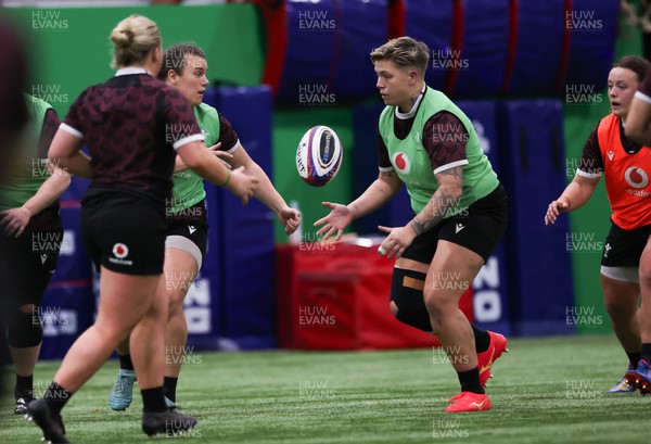 250324 - Wales Women Rugby Training Session  - Carys Phillips passes to Donna Rose during training session ahead of the Guinness Women’s 6 Nations match against England