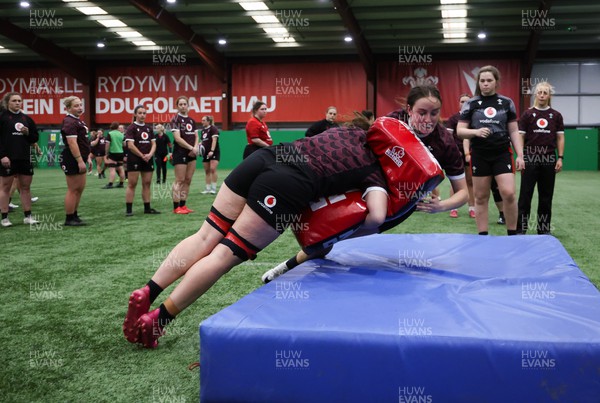 250324 - Wales Women Rugby Training Session  - Nel Metcalfe is tackled during training session ahead of the Guinness Women’s 6 Nations match against England