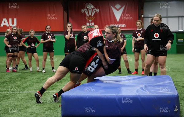 250324 - Wales Women Rugby Training Session  - Amelia Tutt is tackled during training session ahead of the Guinness Women’s 6 Nations match against England