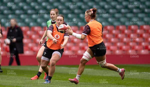 230424 - Wales Women Rugby Training Session - Lleucu George passes to Georgia Evans during a training session at the Principality Stadium ahead of Wales’ Guinness Women’s 6 Nations match against Italy