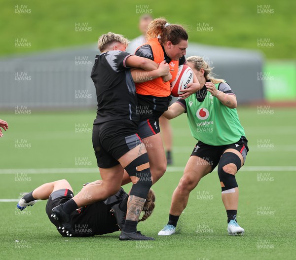 260923 - Wales Women Rugby Training Session - Gwenllian Pyrs is tackled during a training session at Stadium CSM, north Wales
