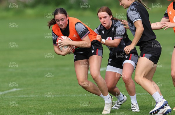 280823 - Wales Women Training Session - Nel Metcalfe is held by Sian Jones during training session