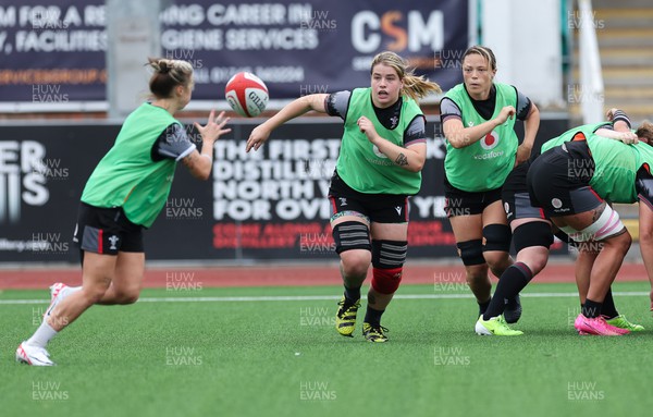 280923 - Wales Women Rugby Training Session - Bethan Lewis passes to Keira Bevan during a training session ahead of the match against USA at Stadium CSM