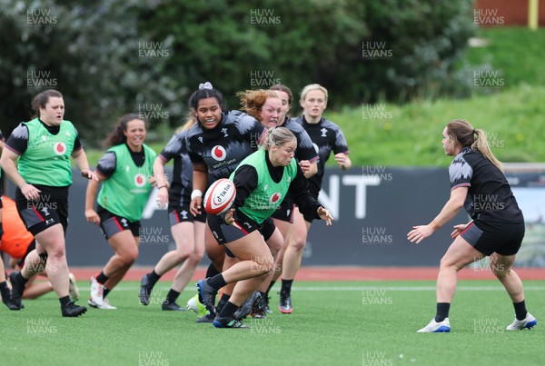 280923 - Wales Women Rugby Training Session - Kelsey Jones gets past Sisilia Tuipulotu during a training session ahead of the match against USA at Stadium CSM