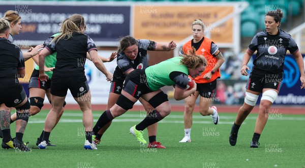 280923 - Wales Women Rugby Training Session - Abbie Fleming is held by Cana Williams during a training session ahead of the match against USA at Stadium CSM