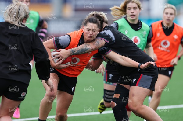 280923 - Wales Women Rugby Training Session - Robyn Wilkins is tackled by Donna Rose during a training session ahead of the match against USA at Stadium CSM