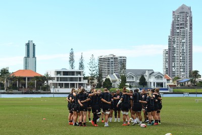 290725 - Wales Women Rugby Training at The Southport School - The Wales Women’s rugby squad huddle up during a training session ahead of the second test against Australia