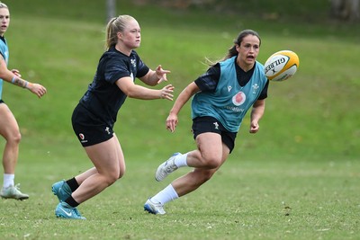 290725 - Wales Women Rugby Training at The Southport School - Seren Lockwood passes the ball watched by Kayleigh Powell during a Wales Women’s rugby training session ahead of the second test against Australia