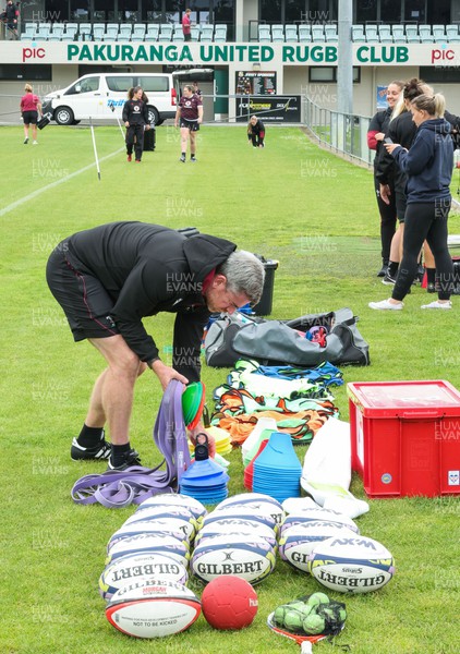 301023 - Wales Women Rugby Training Session - Eifion Roberts, lead strength and conditioning coach, checks the equipment during a training session ahead of their WXV1 match against Australia