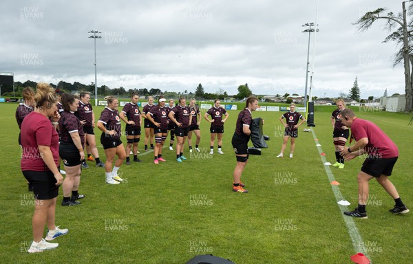 301023 - Wales Women Rugby Training Session - Head coach Ioan Cunningham and coach Catrina Nicholas-McLaughlin work on tackle technique during a training session at Pakuranga United RFC ahead of their WXV1 match against Australia