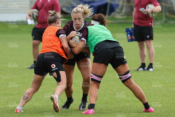 301023 - Wales Women Rugby Training Session - Meg Webb takes on Georgia Evans and Keira Bevan during a training session at Pakuranga United RFC ahead of their WXV1 match against Australia