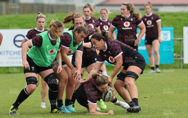 301023 - Wales Women Rugby Training Session - Kat Evans and Sioned Harries take on Carys Phillips and Bethan Lewis during a training session at Pakuranga United RFC ahead of their WXV1 match against Australia