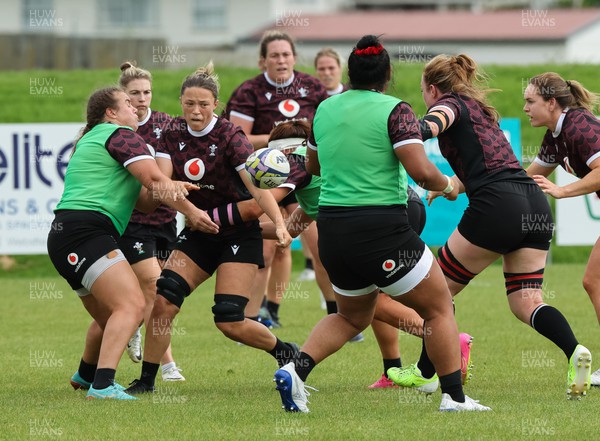 301023 - Wales Women Rugby Training Session - Alisha Butchers off loads during a training session at Pakuranga United RFC ahead of their WXV1 match against Australia