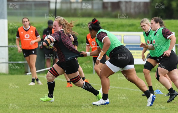 301023 - Wales Women Rugby Training Session - Abbie Fleming breaks away during a training session at Pakuranga United RFC ahead of their WXV1 match against Australia
