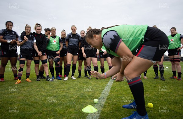 121022 - Wales Women Rugby Training Session - Wales head coach Ioan Cunningham and team mates look on as Carys Phillips plays a team game before a training session ahead of their Women’s Rugby World Cup match against New Zealand