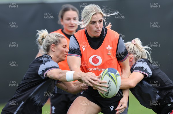 191022 - Wales Women Rugby Training Session - Wales’s Carys Williams-Morris is tackled by Kerin Lake and Megan Webb during training ahead of their Women’s Rugby World Cup match against Australia