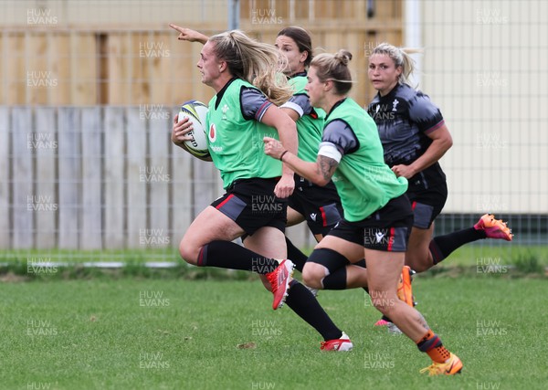 251022 - Wales Women Rugby Training Session - Hannah Jones, Jasmine Joyce , Keira Bevan and Lowri Norkett of Wales race away during training ahead of the Women’s Rugby World Cup Quarter Final against New Zealand