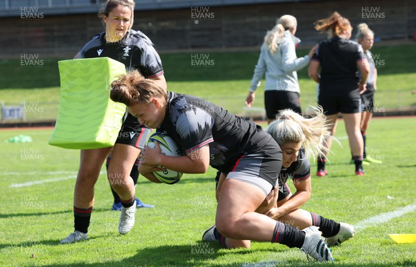 270922 - Wales Women Rugby Training Session - Wales’ Lleucu George is tackled by Lowri Norkett during training ahead of the start of the Women’s Rugby World Cup