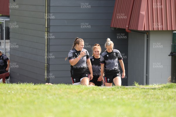 271022 - Wales Women Rugby Training Session - Carys Phillips, Niamh Terry and Megan Webb of Wales walk out for a training session ahead of the Women’s Rugby World Cup Quarter Final against New Zealand