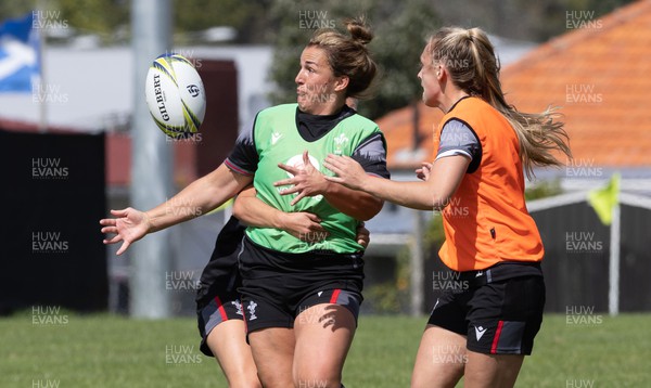 271022 - Wales Women Rugby Training Session - Hannah Jones of Wales offloads to Siwan Lillicrap of Wales during a training session ahead of the Women’s Rugby World Cup Quarter Final against New Zealand